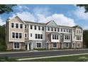 A row of new construction townhomes with varied exterior finishes and crisp white-framed windows at 5029 Jowetts Walk Dr # 29, Cary, NC 27519