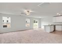 Bright and airy living room with carpet, white walls, recessed lighting, and sliding glass door at 51 Crow Field St, Roxboro, NC 27574