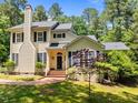 Charming home with brick steps, black door, and lush green lawn, creating a welcoming curb appeal at 676 Whitehurst, Pittsboro, NC 27312