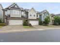 Attractive townhomes with attached garages and diverse exterior designs, set along a street at 707 Newlyn Dr, Raleigh, NC 27606