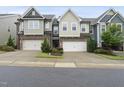 Inviting townhomes showcasing attached garages, landscaped front yards, and varied exterior designs at 707 Newlyn Dr, Raleigh, NC 27606