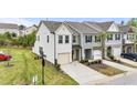Stylish townhome showcasing well-kept lawns, private driveways, and modern design at 72 S Grey Abbey Dr, Clayton, NC 27527