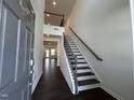 Bright entryway featuring a staircase with dark wood treads and black metal railing at 753 Swim Cave Ln, Wendell, NC 27591