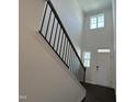 The home's staircase features a white door and dark wooden floors, accented with natural light at 753 Swim Cave Ln, Wendell, NC 27591