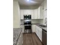 Well-equipped kitchen featuring stainless steel appliances, granite countertops, and ample cabinet space at 805 Da Vinci St, Durham, NC 27704