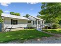 Well-maintained home with white siding, traditional shutters, and a cozy deck area at 8089 Crawford Currin Rd, Oxford, NC 27565