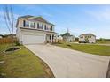 Two-story home with gray siding, black shutters, well maintained lawn, and a spacious driveway at 95 Buckthorn Dr, Youngsville, NC 27596