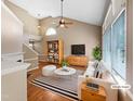Bright living room featuring vaulted ceilings, many windows, and neutral decor at 1005 Augustine Trl, Cary, NC 27518