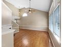 Spacious living room with hardwood floors, fireplace, vaulted ceilings, and abundant natural light at 1005 Augustine Trl, Cary, NC 27518