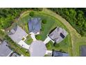 Aerial view of the property showcasing its location in a neighborhood with lush greenery and mature trees at 102 Bella Rose Drive, Chapel Hill, NC 27517