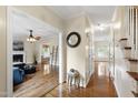 Inviting foyer featuring hardwood floors and decorative details with views into the living and dining room at 102 W Hill Dr, Cary, NC 27519