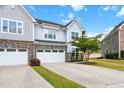 Beautiful two-story home with stone accents, a two-car garage, well-manicured lawn, and a blue sky backdrop at 1021 Benay Rd, Morrisville, NC 27560