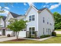 Charming exterior showcasing the house with a manicured lawn, tree, and a combination of siding and stone accents at 1021 Benay Rd, Morrisville, NC 27560