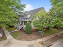 Eye-level corner lot view highlighting mature trees and landscaping, a covered front porch, and charming curb appeal at 10579 Evergreen Spring Pl, Raleigh, NC 27614