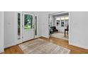 Bright foyer with hardwood floors, a glass-paneled front door, and an open view into the office at 108 Vescova Ln, Morrisville, NC 27560