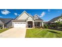 Inviting front exterior with a well-maintained lawn and a two-car garage and neutral colors at 1085 Lobdale Ct, Burlington, NC 27215