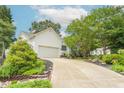 Charming home featuring a two-car garage, well-manicured lawn, and beautiful landscaping at 1113 Pilton Pl, Raleigh, NC 27604