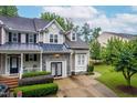 Charming home with stone accents, metal roof, and meticulously maintained landscaping at 112 River Dell Townes Ave, Clayton, NC 27527