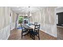 Bright dining room with modern chandelier and sliding glass doors to outdoor space at 1200 Collington Dr, Cary, NC 27511