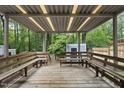 Spacious covered patio with wooden benches, perfect for outdoor gatherings at 1200 Collington Dr, Cary, NC 27511