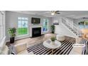 Bright living room featuring a fireplace, hardwood floors, and modern decor at 1216 Briarwood Dr, Mebane, NC 27302