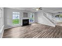 Spacious living area with large windows, hardwood floors, and a cozy fireplace at 1216 Briarwood Dr, Mebane, NC 27302