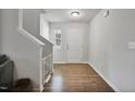 Bright foyer with hardwood floors, white walls, and staircase leading to the second floor at 124 Teagarden Ct, Sanford, NC 27332