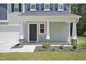 Inviting front porch with decorative pillars, stone accents, and a welcoming entrance at 124 Teagarden Ct, Sanford, NC 27332