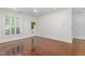 Sun-drenched bedroom with hardwood floors, large window, and direct access to a porch at 1310 Durlain Dr # 107, Raleigh, NC 27614
