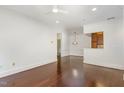 Bright living room with hardwood floors and modern lighting, flowing into dining area at 1310 Durlain Dr # 107, Raleigh, NC 27614
