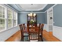 Formal dining room featuring blue walls, white trim, and a traditional chandelier at 1332 Kinsdale Dr, Raleigh, NC 27615