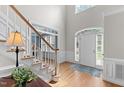 Bright foyer with hardwood floors, staircase, and arched transom window above front door at 1332 Kinsdale Dr, Raleigh, NC 27615