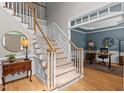 Elegant staircase with carpeted treads and white risers, leading to an office space at 1332 Kinsdale Dr, Raleigh, NC 27615