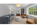 Cozy living room with light-filled window and stylish decor at 1706 Rangecrest Rd, Raleigh, NC 27612
