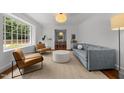 Bright living room with a large window and contemporary furniture at 1706 Rangecrest Rd, Raleigh, NC 27612