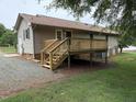 Exterior view of a wood deck with stairs leading down to the backyard at 1942 Brier Ln, Graham, NC 27253