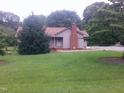 Charming single-story home with a brick chimney and a well-maintained lawn at 1942 Brier Ln, Graham, NC 27253