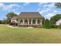 Beautiful one-story home with a covered front porch and well-maintained landscaping at 20 Wood Ibis Way, Louisburg, NC 27549