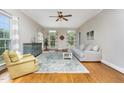 Bright living room with hardwood floors, large windows, and comfortable seating at 20 Wood Ibis Way, Louisburg, NC 27549