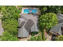 Aerial view of a home with a swimming pool and lush green trees surrounding the property at 2001 Dobson Ct, Raleigh, NC 27612