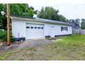 Spacious detached garage with white siding and ample parking space at 2016 Tryon Rd, Raleigh, NC 27603