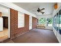 Relaxing screened-in porch with brick accents and a comfortable porch swing at 2016 Tryon Rd, Raleigh, NC 27603
