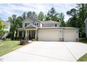 Two-story home showcasing its double garage and clean, well-maintained lawn and landscaping at 212 Hardwick St, Clayton, NC 27527