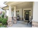 Inviting front porch with stone accents, seating, and a clear view of the front door at 212 Hardwick St, Clayton, NC 27527