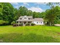 Beautifully landscaped front yard with a classic white home and inviting porch at 228 Birch Creek Dr, Fuquay Varina, NC 27526