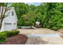 Spacious two-car garage with RV parking surrounded by lush greenery at 228 Birch Creek Dr, Fuquay Varina, NC 27526