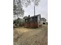 Another angle of the side exterior, showing the house, adjacent yard, and surrounding landscape at 2503 Chapel Hill Rd, Durham, NC 27707