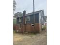 Side view of the charming single-Gathering house, highlighting brick foundation and exterior details at 2503 Chapel Hill Rd, Durham, NC 27707