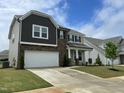 Lovely two-story home with a two-car garage, stone accents, and a beautifully landscaped yard at 30 Junius Birch Trl, Franklinton, NC 27525