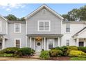 Charming two-story townhome with landscaped front yard, great daytime lighting, and an inviting entrance at 3021 White Cloud Cir, Apex, NC 27502